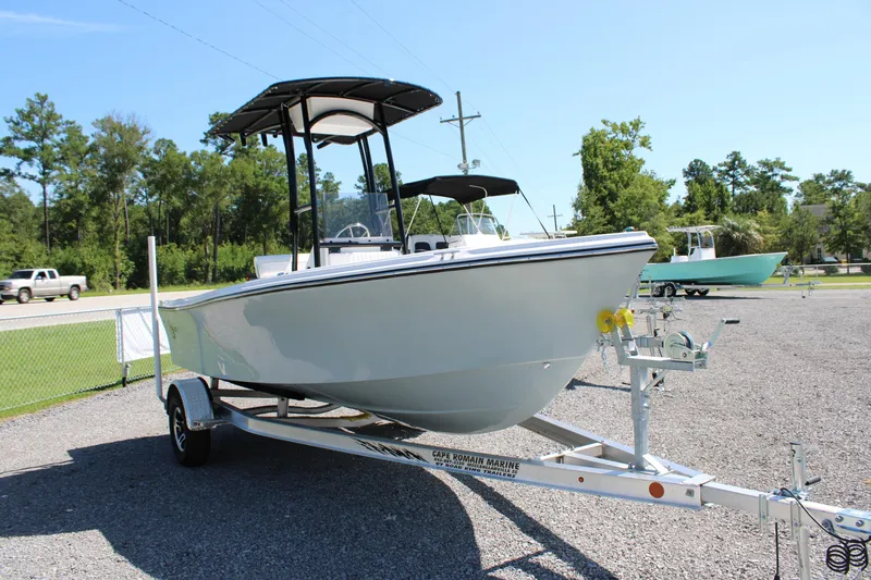 Slide: The Image of 2025 C-Hawk 19CC boat on trailer, parked outdoors on a sunny day. - 25