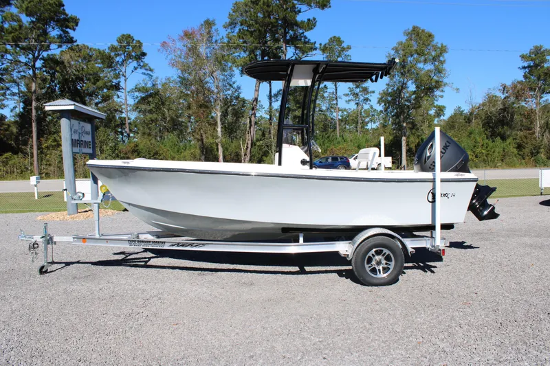 Slide: The Image of 2025 C-Hawk 19CC boat on trailer, parked outdoors near trees. - 26