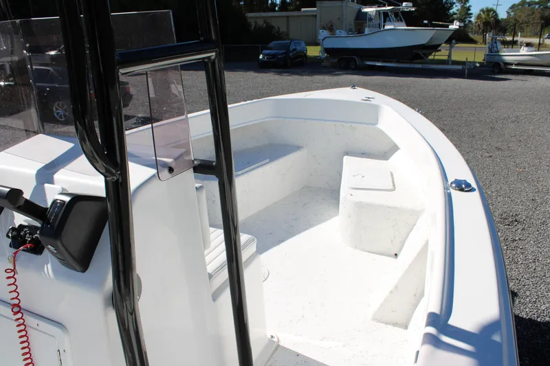 Slide: The Image of 2025 C-Hawk 19CC boat interior with console and seating, parked on gravel. - 30