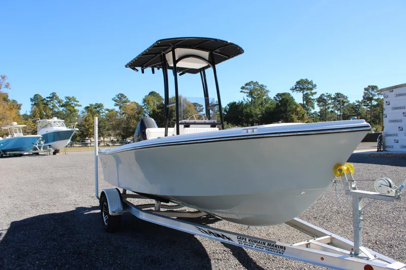 Slide: The Image of 2025 C-Hawk 19CC boat on trailer, parked outdoors under clear blue sky. - 31