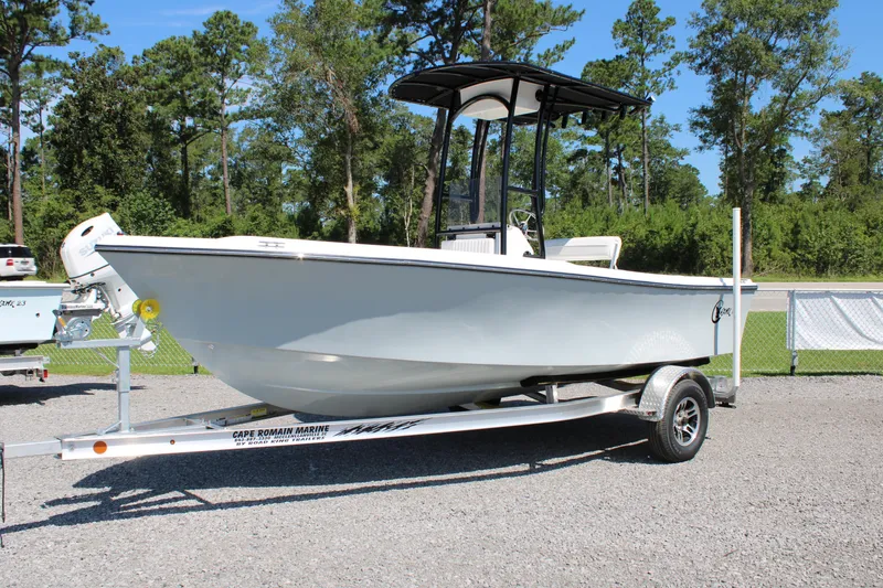 Slide: The Image of 2025 C-Hawk 19CC boat on trailer, parked outdoors with trees in background. - 5