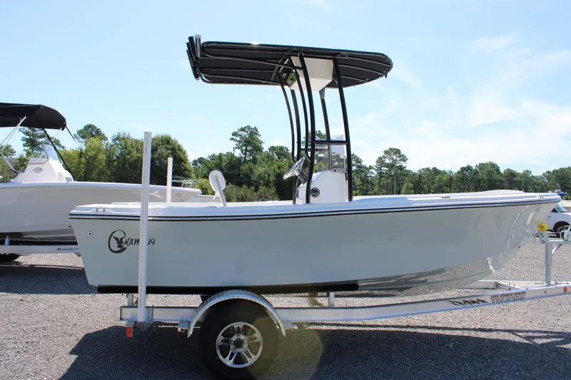 Slide: The Image of 2025 C-Hawk 19CC boat on trailer, displayed outdoors under clear sky. - 7