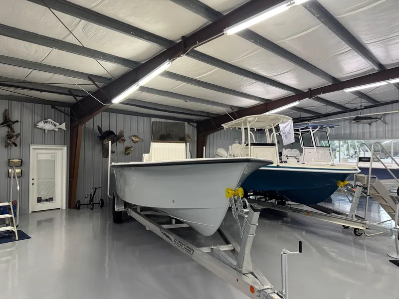 Slide: The Image of 2026 C-Hawk 25 boats in a showroom, displayed on trailers. - 10