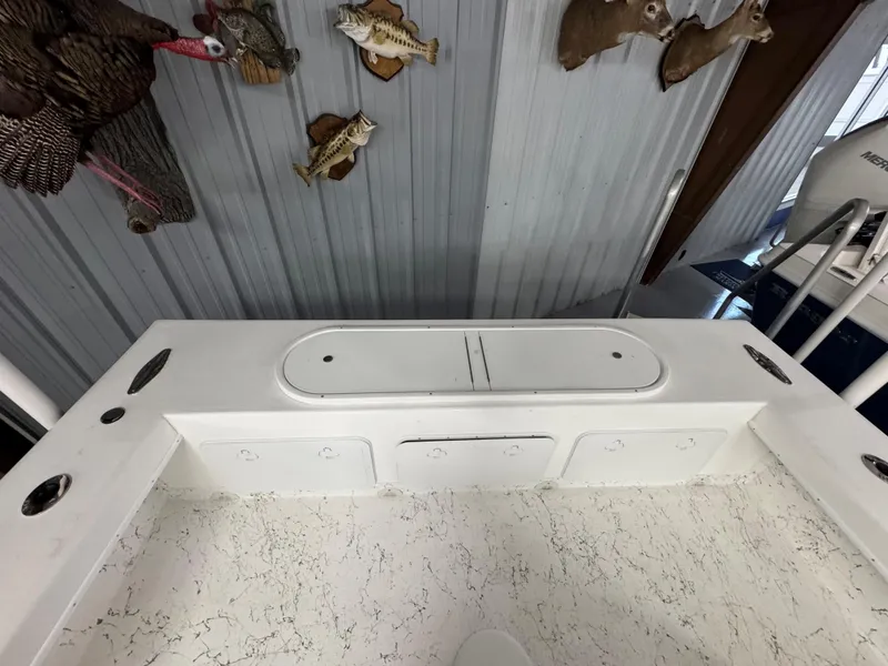 Slide: The Image of 2026 C-Hawk 25 boat interior with storage compartments, mounted fish and deer decor. - 14