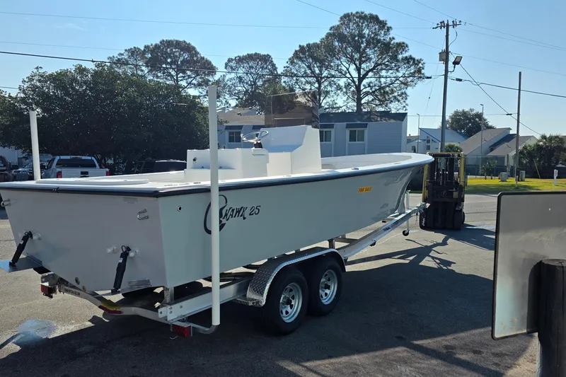 Slide: The Image of 2026 C-Hawk 25 boat on trailer, parked outdoors under clear sky. - 4