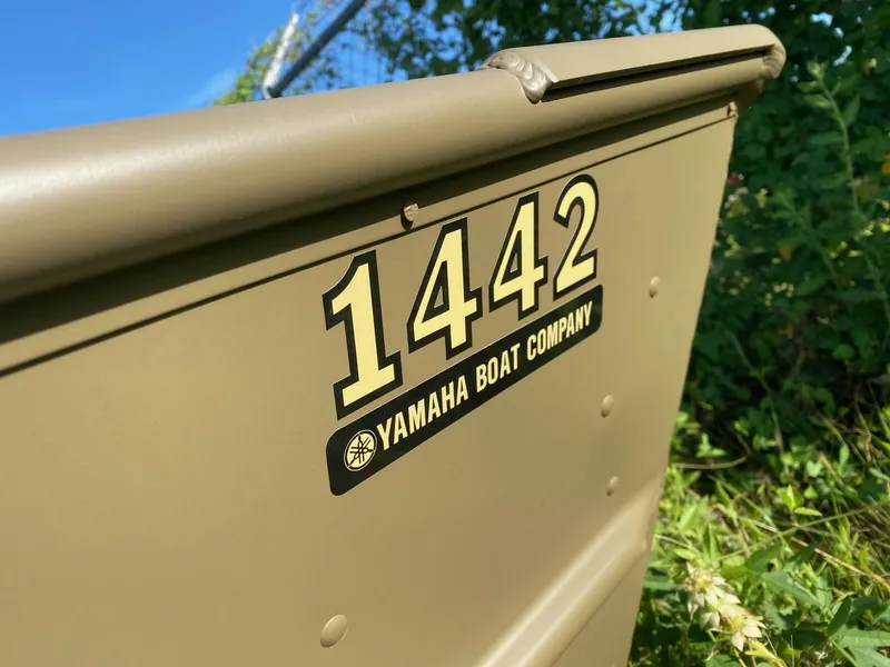 Slide: The Image of 2025 G3 Gator Tough 1442 boat, Yamaha branding, outdoors with greenery background. - 3