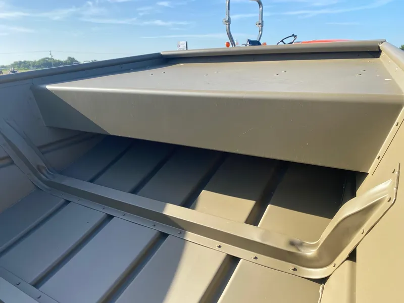 Slide: The Image of 2025 G3 Gator Tough 1442 boat interior with storage compartment under clear blue sky. - 4