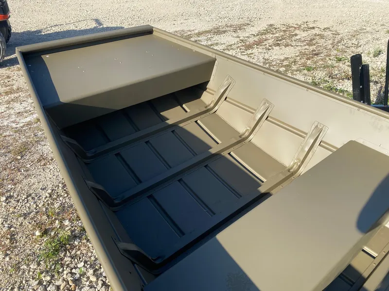 Slide: The Image of 2025 G3 Gator Tough 1442 boat interior with bench seats on gravel surface. - 6