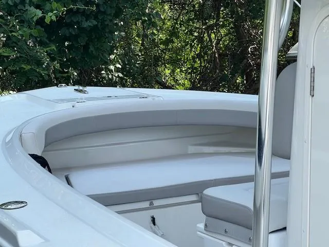 Slide: The Image of 2023 Parker 21SE Center Console boat with cushioned seating, surrounded by lush greenery. - 11