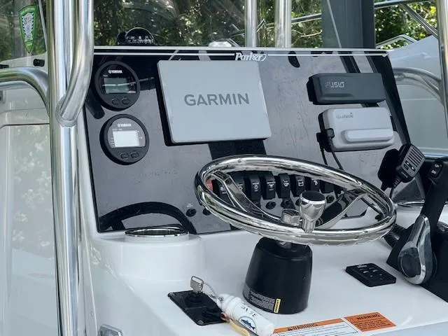 Slide: The Image of 2023 Parker 21SE Center Console dashboard with Garmin navigation and Yamaha controls. - 12