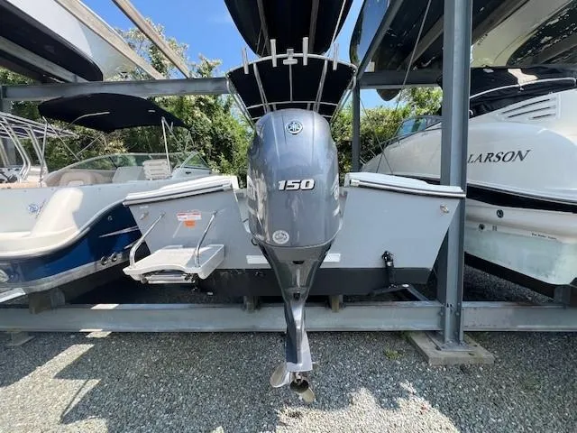 Slide: The Image of 2023 Parker 21SE Center Console boat with Yamaha 150 outboard motor in storage. - 15