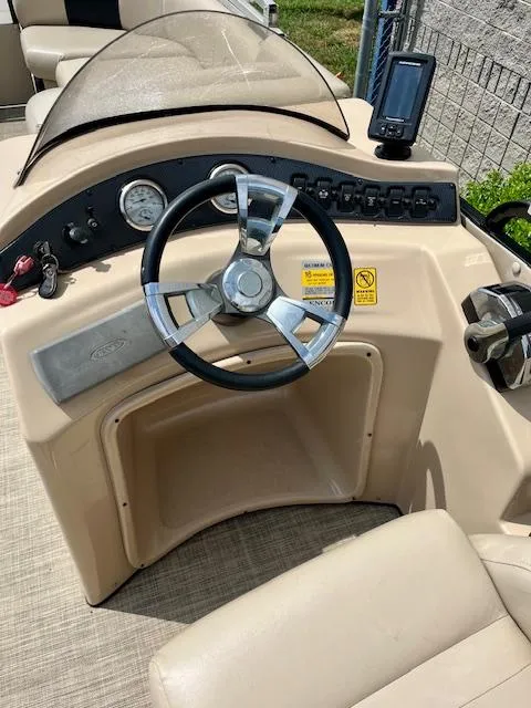 Slide: The Image of 2012 Bentley Pontoons 250/253 Party Cruise dashboard with steering wheel and controls. - 12