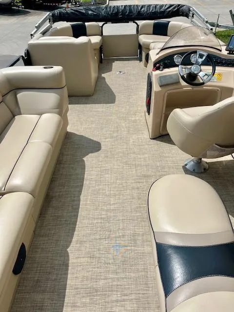 Slide: The Image of 2012 Bentley Pontoons 250/253 Party Cruise interior with beige seating and steering console. - 14