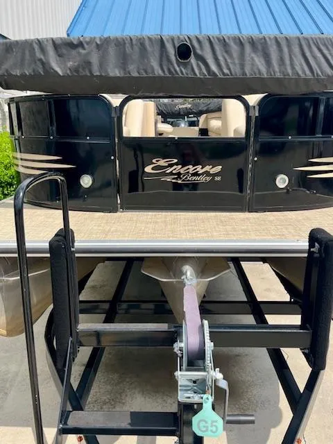 Slide: The Image of 2012 Bentley Pontoons 250/253 Party Cruise on trailer, featuring sleek black design. - 4