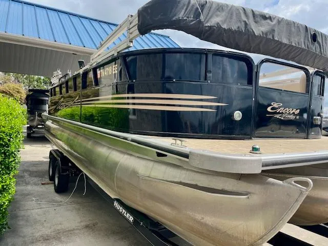 Slide: The Image of 2012 Bentley Pontoons 250/253 Party Cruise boat with blue canopy, parked on trailer. - 5