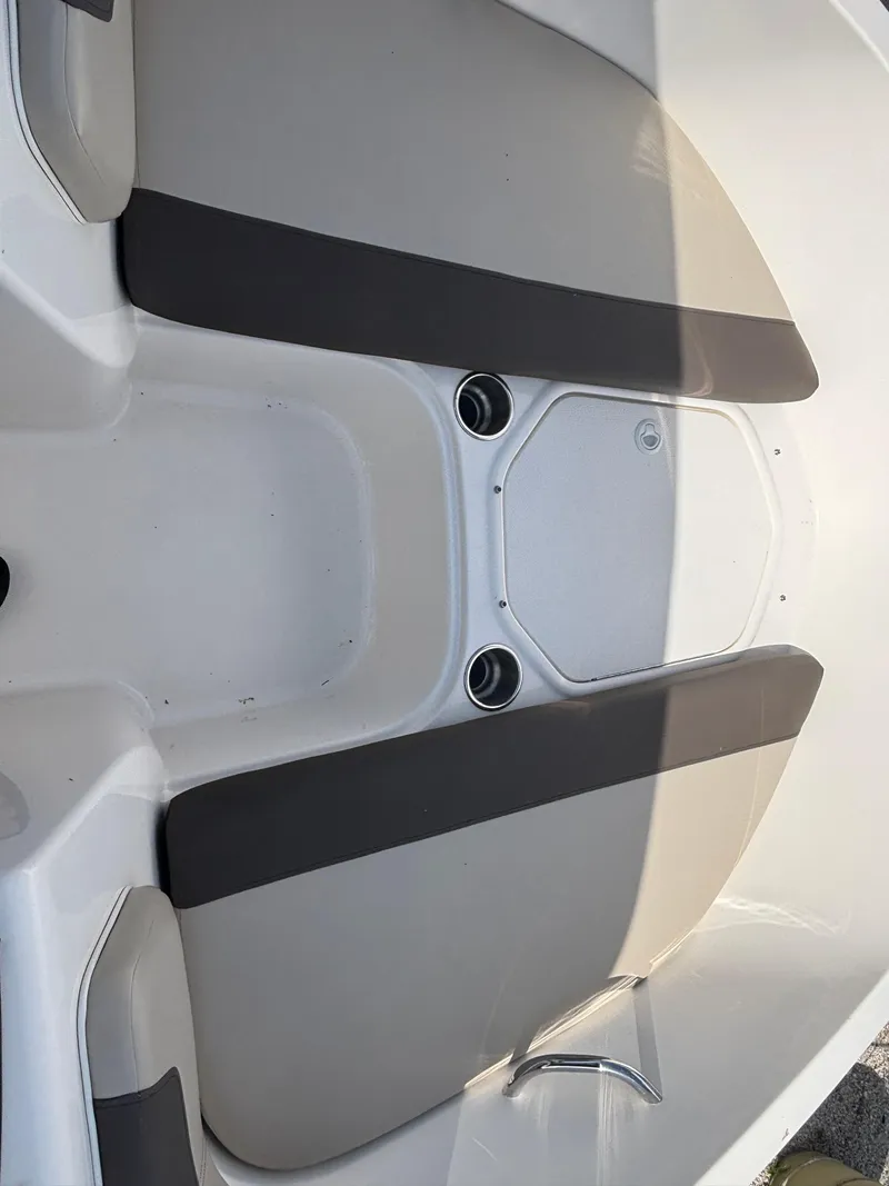 Slide: The Image of 2018 Bayliner Element F21 boat interior with gray seating and cup holders. - 29