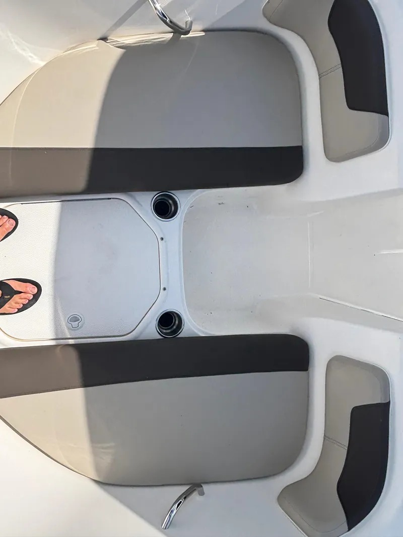 Slide: The Image of 2018 Bayliner Element F21 boat interior with gray seating and cup holders. - 30