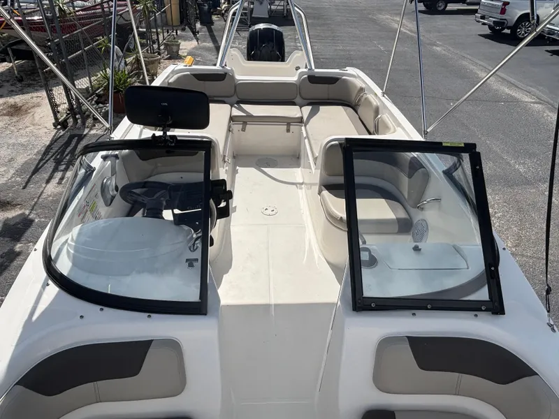 Slide: The Image of 2018 Bayliner Element F21 boat interior with open windshield and seating area. - 31