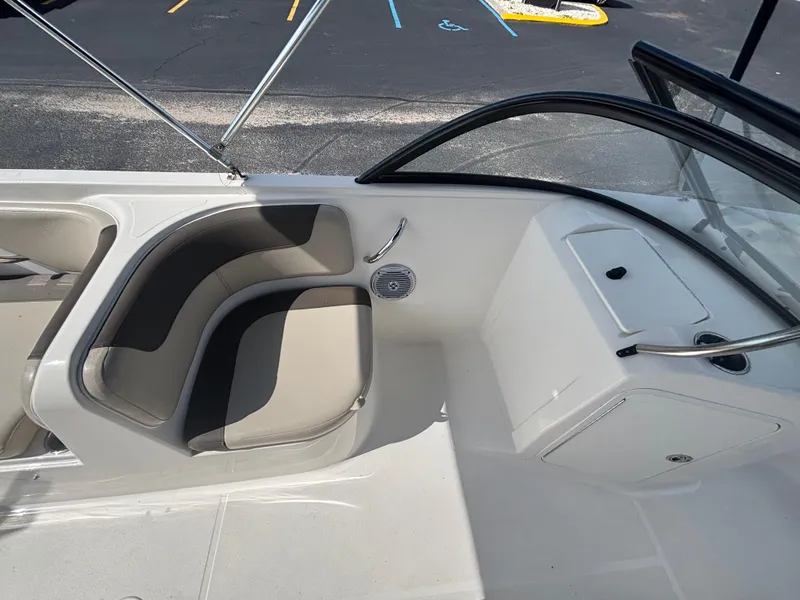 Slide: The Image of 2018 Bayliner Element F21 boat interior with seating and storage compartments. - 35