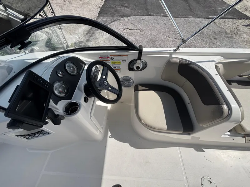 Slide: The Image of 2018 Bayliner Element F21 boat cockpit with steering wheel and seating. - 36