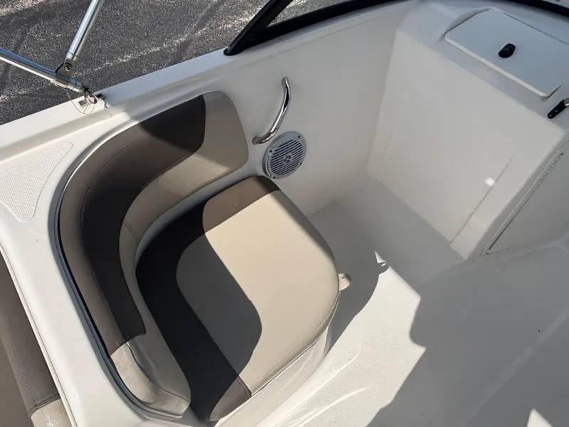 Slide: The Image of 2018 Bayliner Element F21 boat interior with cushioned seating and speaker. - 27