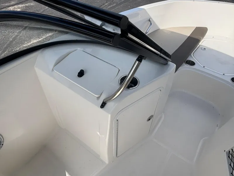 Slide: The Image of 2018 Bayliner Element F21 boat interior with storage compartment and seating area. - 32