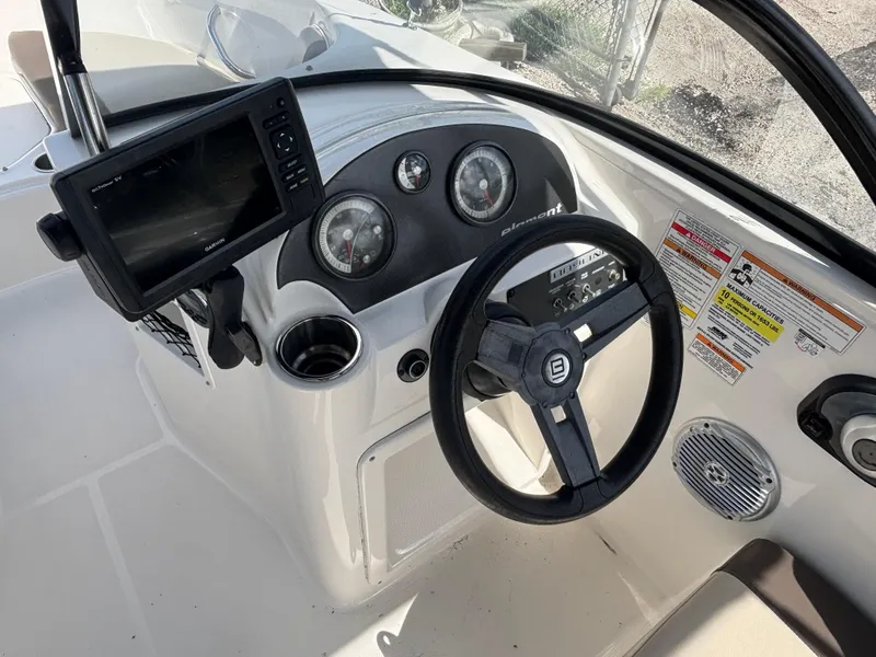 Slide: The Image of 2018 Bayliner Element F21 boat dashboard with steering wheel and navigation system. - 33