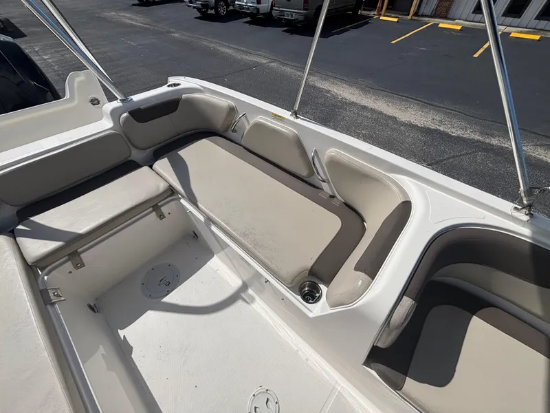 Slide: The Image of 2018 Bayliner Element F21 boat interior with beige seating and storage compartments. - 39
