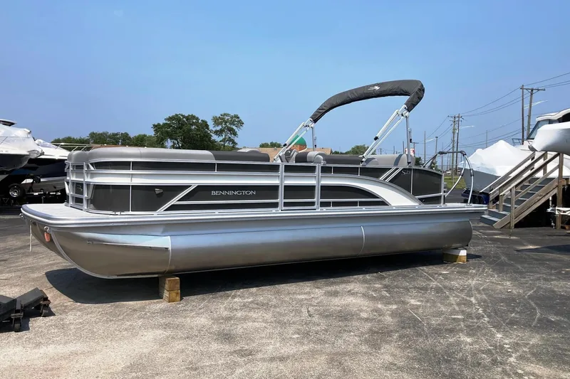 The Image of 2025 Bennington 23 SSB pontoon boat on display in a marina setting. - 0