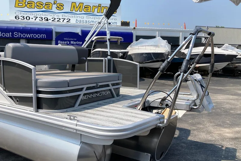 Slide: The Image of 2025 Bennington 23 SSB pontoon boat at Basa's Marine showroom. - 2