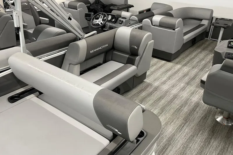 Slide: The Image of 2025 Bennington 23 SSB boat interior with gray seating and modern design. - 5