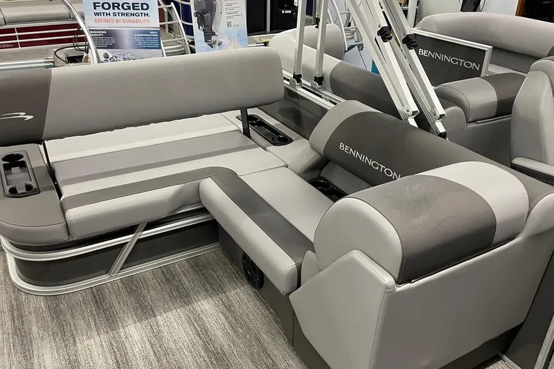 Slide: The Image of 2025 Bennington 23 SSB pontoon boat interior with gray seating and cup holders. - 6