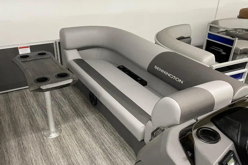 Slide: The Image of 2025 Bennington 23 SSB pontoon boat interior with gray seating and cup holders. - 8