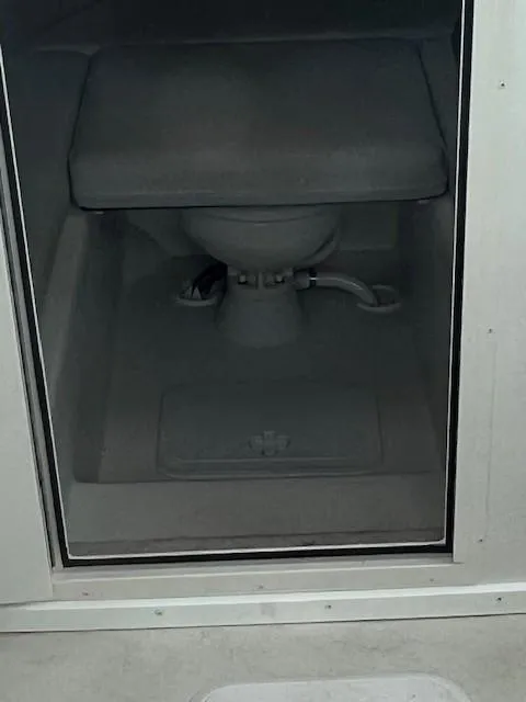 Slide: The Image of Interior view of a 2021 Parker 2520 XLD Sport Cabin boat's compact toilet area. - 15