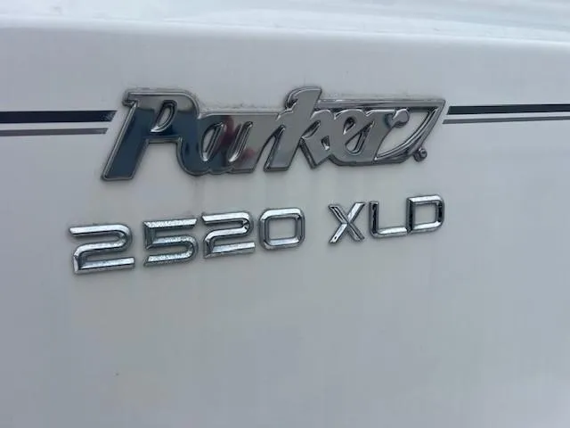 Slide: The Image of 2021 Parker 2520 XLD Sport Cabin boat emblem on white surface. - 20