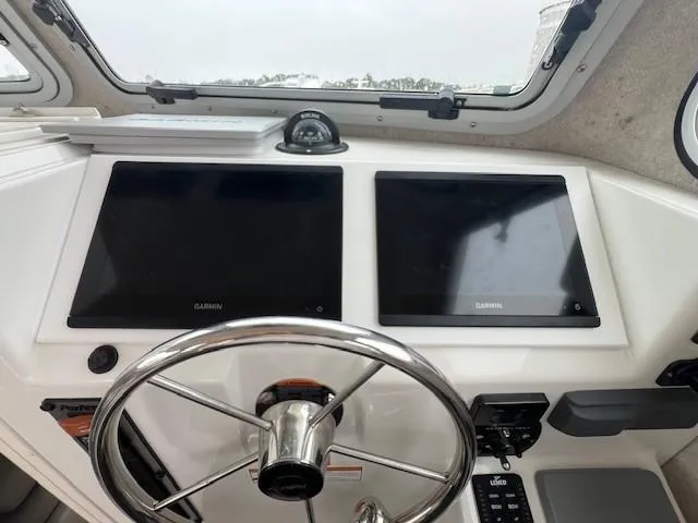 Slide: The Image of 2021 Parker 2520 XLD Sport Cabin helm with dual Garmin displays and steering wheel. - 26