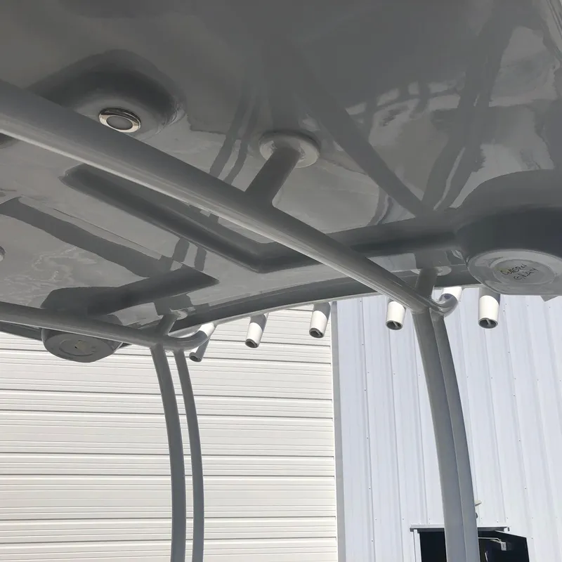 Slide: The Image of 2026 Pair Customs 24 Center Console DV boat roof with rod holders and sleek design. - 11