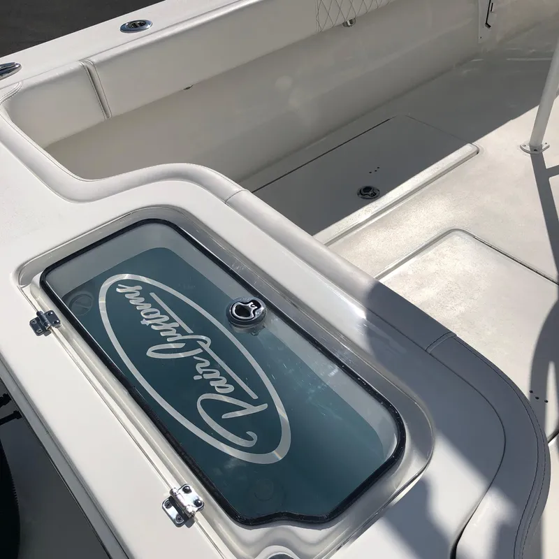 Slide: The Image of 2026 Pair Customs 24 Center Console DV boat interior with branded storage compartment. - 13