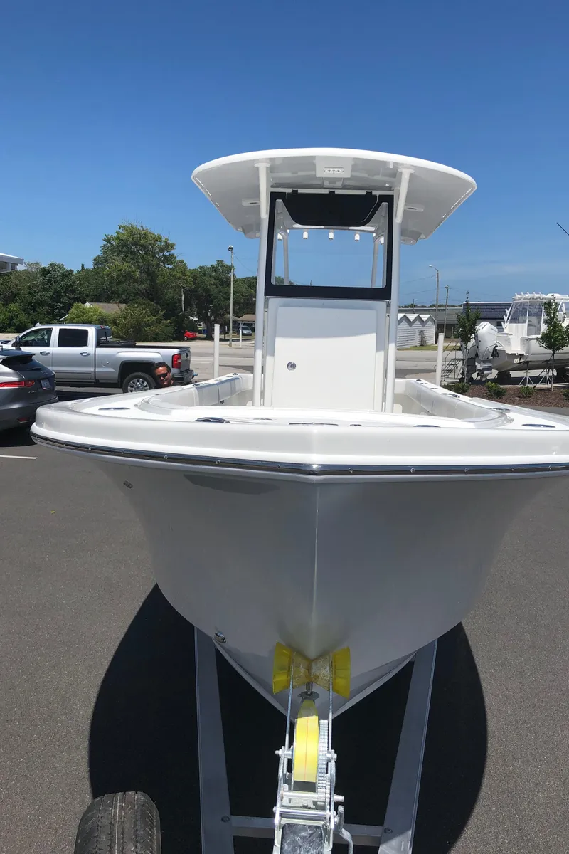Slide: The Image of 2026 Pair Customs 24 Center Console DV boat on trailer in parking lot. - 21