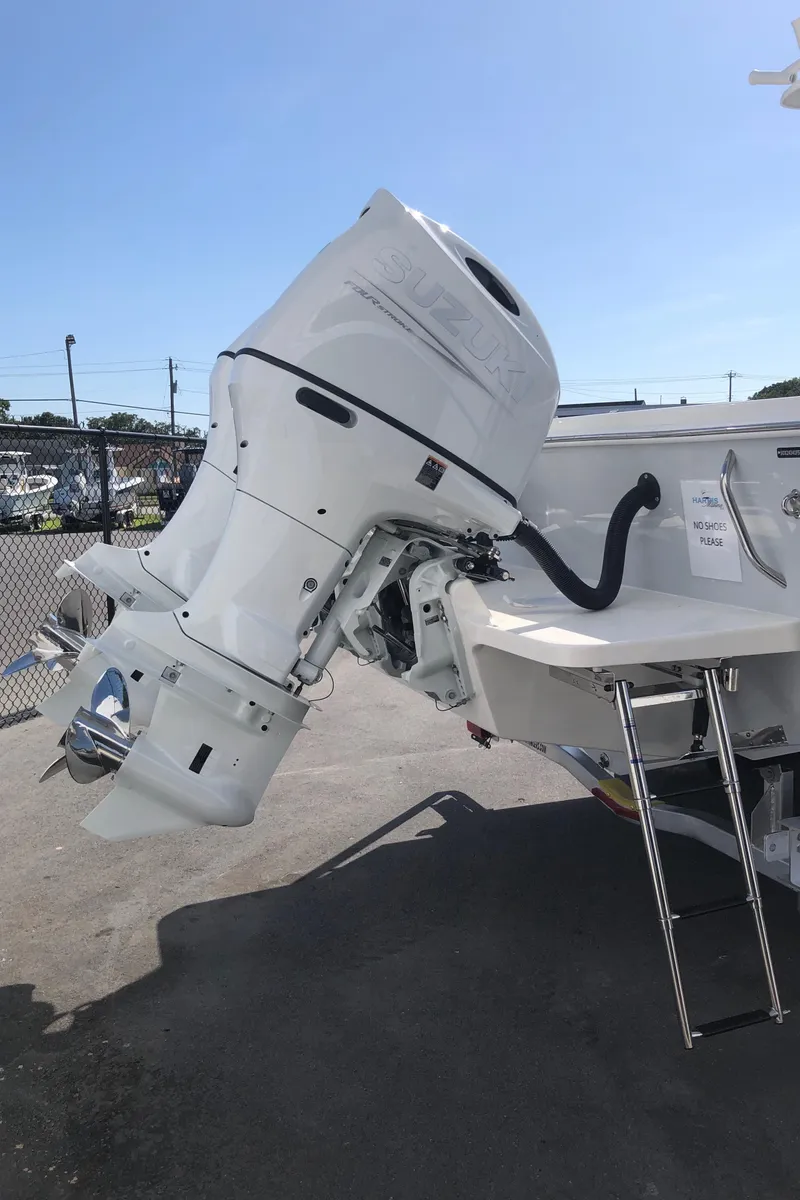 Slide: The Image of 2026 Pair Customs 24 Center Console DV with Suzuki outboard motor and ladder. - 22