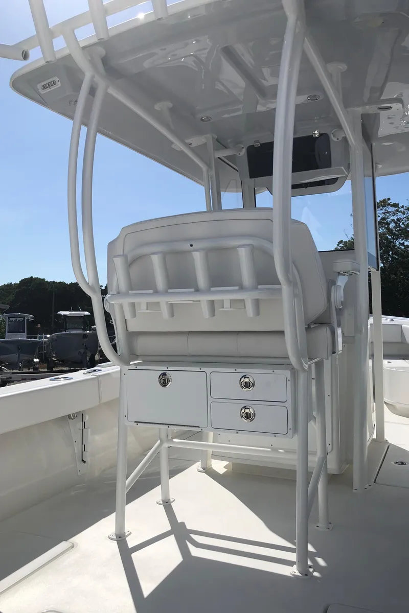 Slide: The Image of 2026 Pair Customs 24 Center Console DV boat interior with seating and storage. - 23