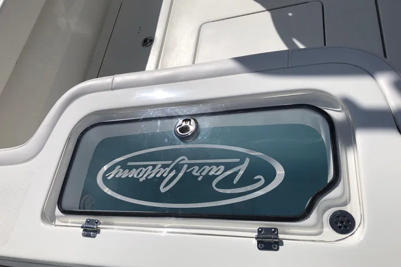 Slide: The Image of 2026 Pair Customs 24 Center Console DV boat detail with logo on hatch. - 24