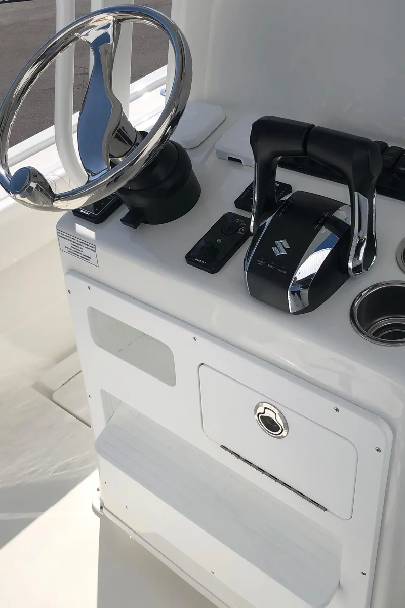 Slide: The Image of 2026 Pair Customs 24 Center Console DV helm with steering wheel and controls. - 25