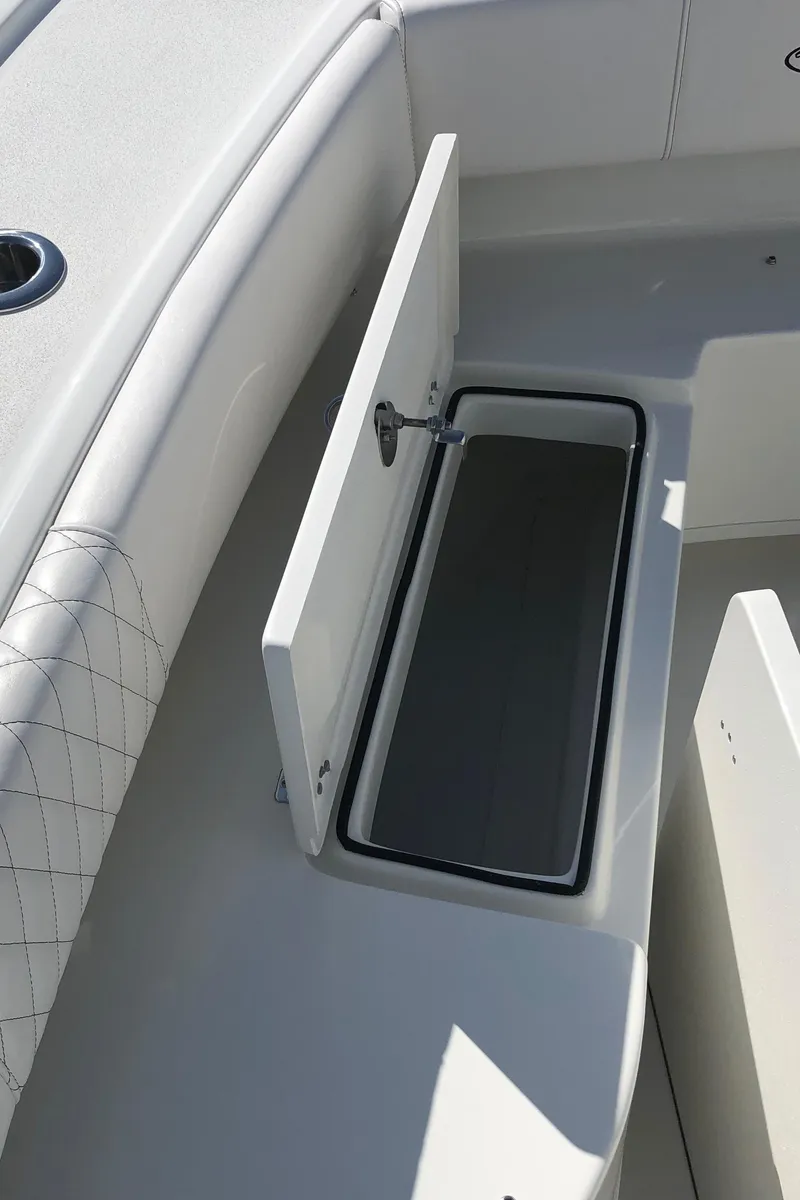 Slide: The Image of 2026 Pair Customs 24 Center Console DV boat with open storage compartment. - 28