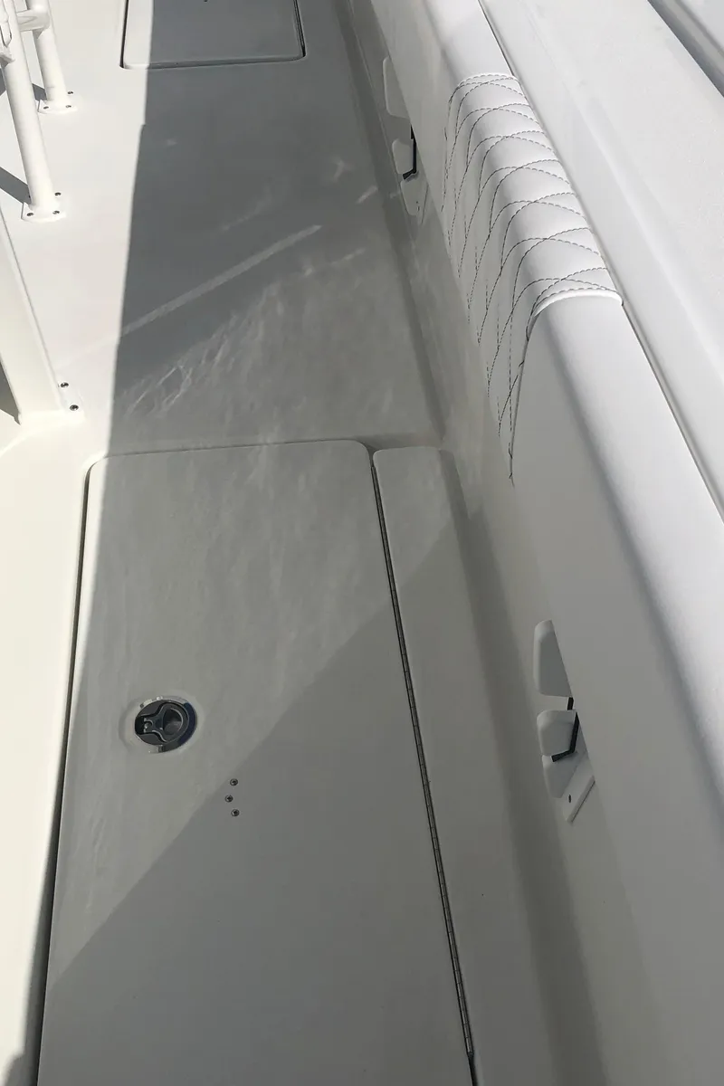 Slide: The Image of 2026 Pair Customs 24 Center Console DV boat deck with sleek design and white finish. - 29