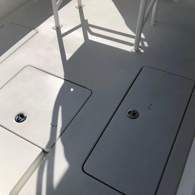 Slide: The Image of 2026 Pair Customs 24 Center Console DV boat deck with storage compartments. - 3