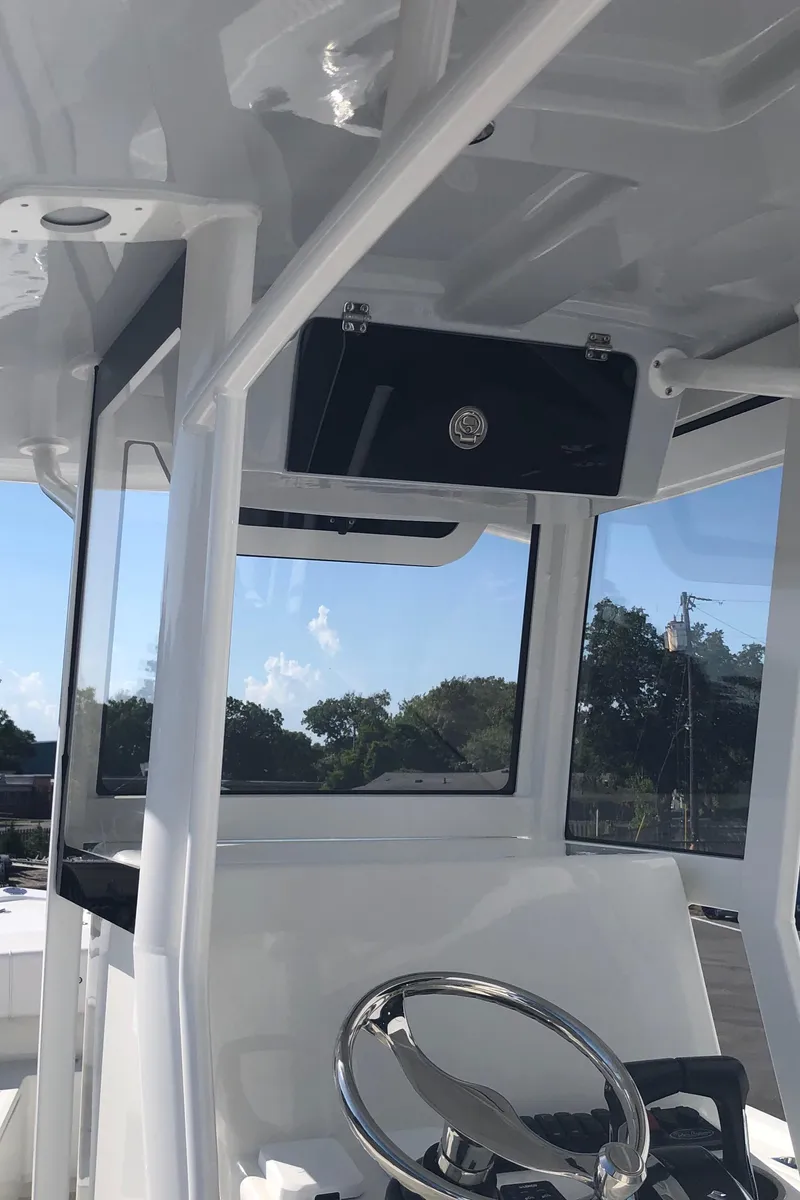 Slide: The Image of 2026 Pair Customs 24 Center Console DV boat interior with steering wheel and console. - 36