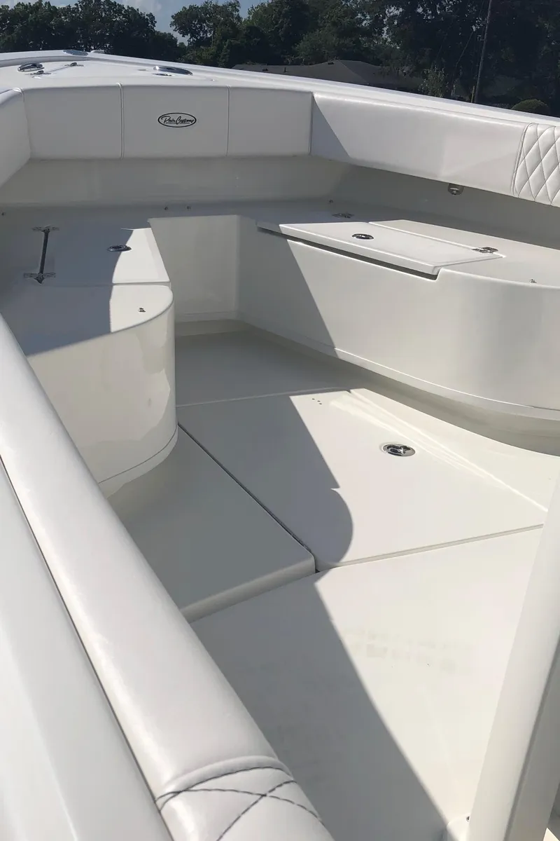 Slide: The Image of 2026 Pair Customs 24 Center Console DV boat interior with white seating and spacious deck. - 37