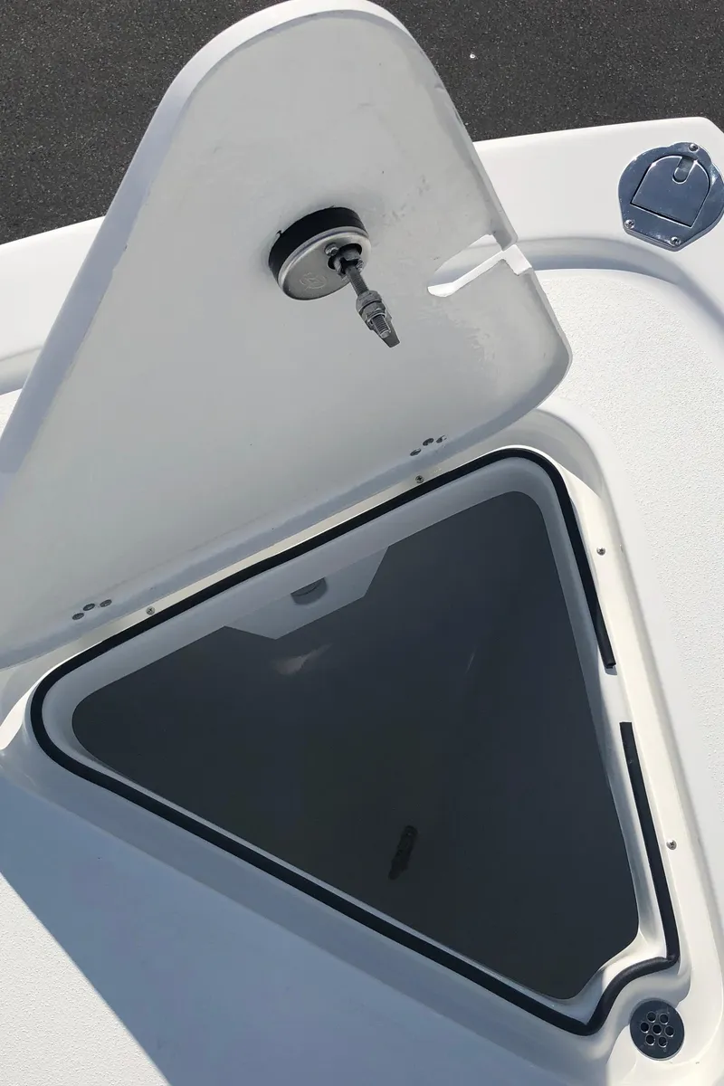 Slide: The Image of Open storage compartment on 2026 Pair Customs 24 Center Console DV boat. - 38