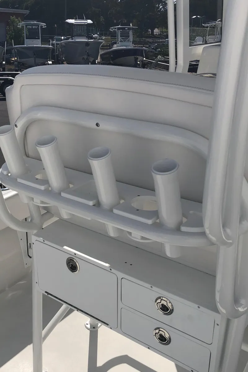 Slide: The Image of 2026 Pair Customs 24 Center Console DV boat with rod holders and storage compartments. - 41